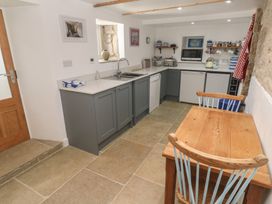 A kitchen with cabinets and appliances at 12 Boswedden Terrace in St Just