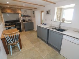 A kitchen with cabinets and appliances at 12 Boswedden Terrace St Just