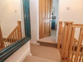 A hallway with a staircase and a door at 12 Boswedden Terrace in St Just