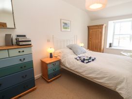 A bedroom with a bed and dresser at 12 Boswedden Terrace St Just