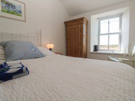 A bedroom with a bed and wardrobe at 12 Boswedden Terrace St Just