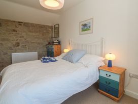 A bedroom with a bed and bedside table at 12 Boswedden Terrace in St Just
