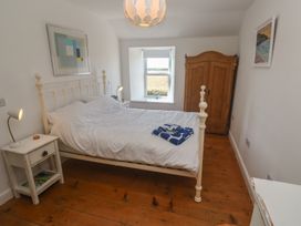 A bedroom with a bed and wardrobe at 12 Boswedden Terrace in St Just