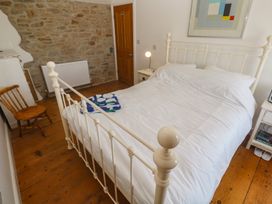 A bedroom with a bed and bedside table at 12 Boswedden Terrace St Just