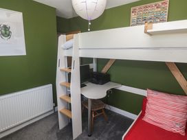 A bedroom with a bunk bed and desk at 12 Boswedden Terrace in St Just