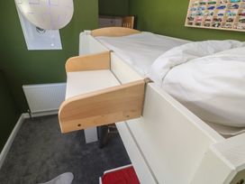 A loft bed with bedding in a bedroom at 12 Boswedden Terrace St Just