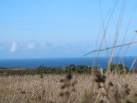 A view of the ocean and clouds from grassland at 12 Boswedden Terrace St Just