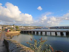 A view of a harbor with a bridge and boats at 12 Boswedden Terrace St Just