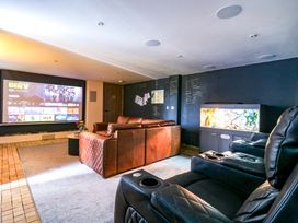 A media room with a projector screen and sofa at Manor Farm House in Merton near Bicester