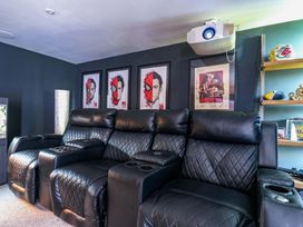 A home theater with recliner sofa and projector at Manor Farm House in Merton near Bicester