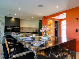A kitchen with a large island and plates on the counter at Manor Farm House in Merton near Bicester