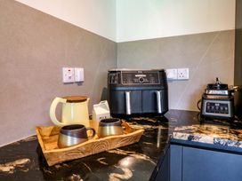 A kitchen with a kettle and cups on a tray at Manor Farm House Merton near Bicester