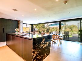 A kitchen with a central island and access to an outdoor patio at Manor Farm House in Merton near Bicester