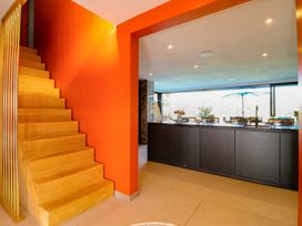 A kitchen with a staircase and counter at Manor Farm House in Merton near Bicester