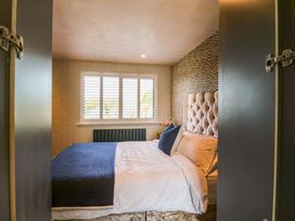 A bedroom with a bed and window at Manor Farm House in Merton near Bicester
