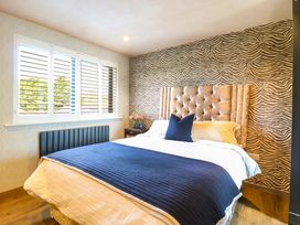 A bedroom with a bed and window at Manor Farm House in Merton near Bicester