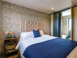 A bedroom with a bed and bedside table at Manor Farm House in Merton near Bicester