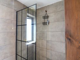 A shower with a glass enclosure in a bathroom at Manor Farm House in Merton near Bicester