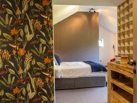A bedroom with a bed and nightstand at Manor Farm House in Merton near Bicester