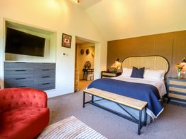 A bedroom with a bed and nightstands at Manor Farm House in Merton near Bicester