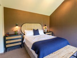 A bedroom with a bed and bedside tables at Manor Farm House in Merton near Bicester