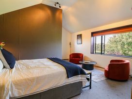 A bedroom with a bed and seating area at Manor Farm House in Merton near Bicester