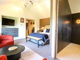 A bedroom with a bed and a television at Manor Farm House in Merton near Bicester