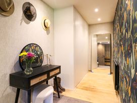 A hallway with a console table and hats on the wall at Manor Farm House in Merton near Bicester