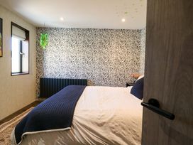 A bedroom with a bed and window at Manor Farm House in Merton near Bicester