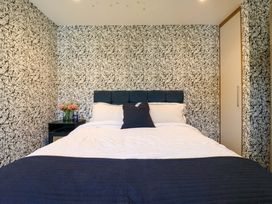 A bedroom with a bed and bedside table at Manor Farm House in Merton near Bicester