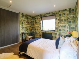 A bedroom with a bed and a nightstand at Manor Farm House in Merton near Bicester
