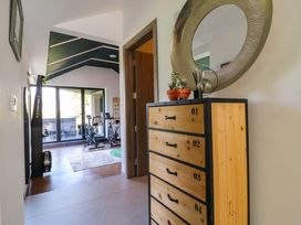 A hallway with a dresser and exercise equipment at Manor Farm House in Merton near Bicester
