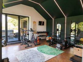 A gym with exercise equipment and a view at Manor Farm House in Merton near Bicester
