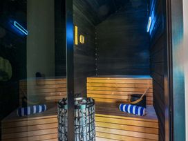 A sauna with wooden benches and a bucket at Manor Farm House in Merton near Bicester