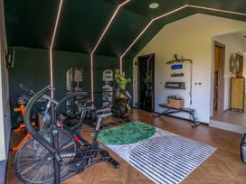 A gym with exercise equipment and weights at Manor Farm House in Merton near Bicester