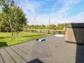 An outdoor area with a hot tub and exercise equipment at Manor Farm House in Merton near Bicester