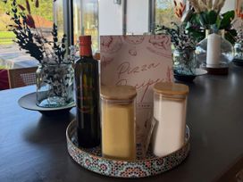 A kitchen counter with olive oil and recipe book at Manor Farm House Merton near Bicester