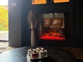 A living room featuring a fireplace and decorative items at Manor Farm House in Merton near Bicester