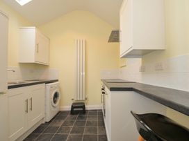A kitchen with cabinets and appliances at Violet's Rest in Exeter