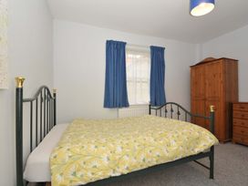 A bedroom with a bed and wardrobe at Violet's Rest in Exeter