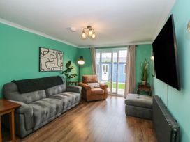 A living room with a sofa and television at 61 Lloyd Street West Llandudno