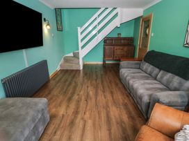 A living room with a sofa and television at 61 Lloyd Street West Llandudno