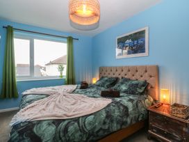 A bedroom with a bed and nightstand at 61 Lloyd Street West in Llandudno