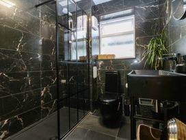 A bathroom with shower, toilet and sink at 61 Lloyd Street West in Llandudno