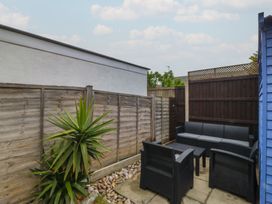 A garden area with seating on a patio at 61 Lloyd Street West in Llandudno