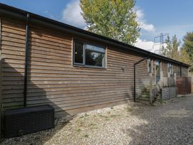 A building exterior with windows and a staircase at Willow Cottage in Whiteparish