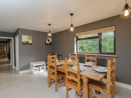 A dining room with a wooden table and chairs at Willow Cottage in Whiteparish