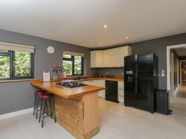 A kitchen with a sink, stove, and refrigerator at Willow Cottage in Whiteparish