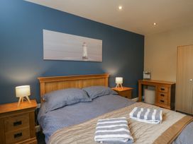 A bedroom with a bed and bedside tables at Willow Cottage in Whiteparish
