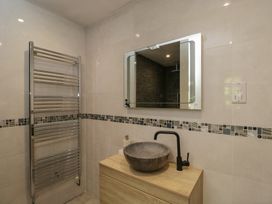 A bathroom with a towel radiator and a sink at Willow Cottage Whiteparish